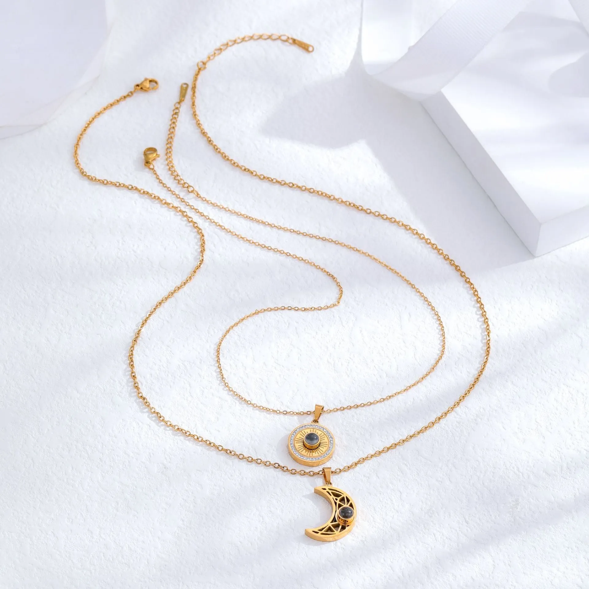 Gold sun and moon projection matching necklaces for couples